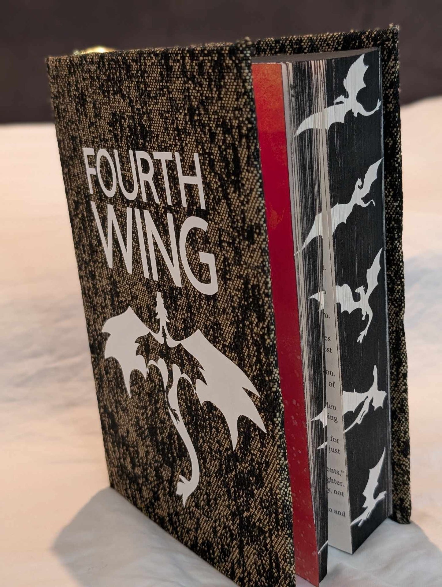 The Booktok Book sensation Fourth Wing  rebound with book binding with custom covers. Made with Leather and Vinyl right here in Canada!