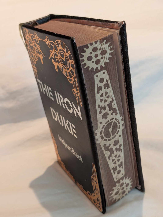 The original Booktok steampunk Book sensation The Iron Duke  rebound with book binding with custom covers. Made with Leather and Vinyl right here in Canada!