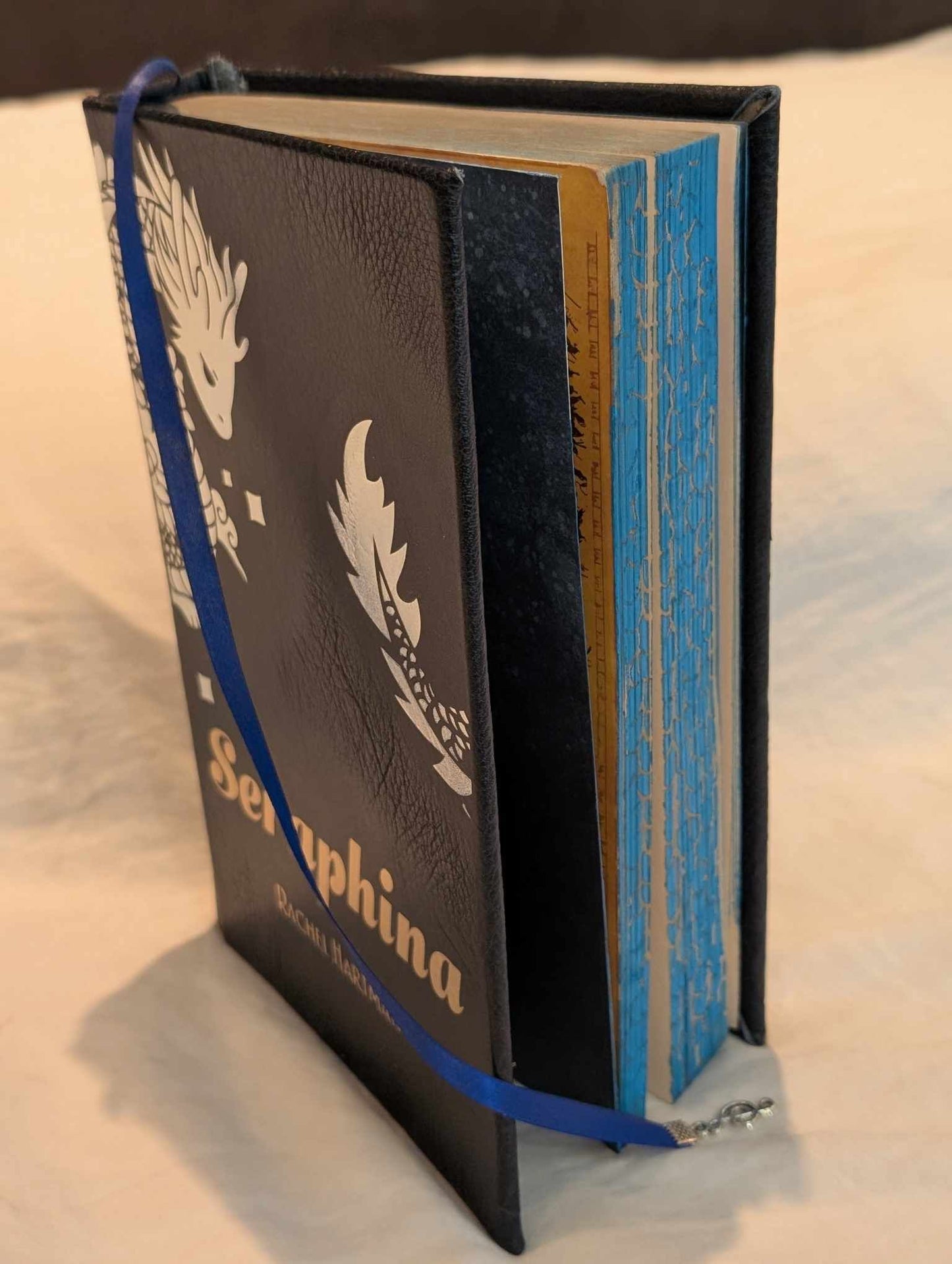 The Booktok Book Seraphina of some  rebound with book binding with custom covers. Made with Leather and Vinyl right here in Canada!