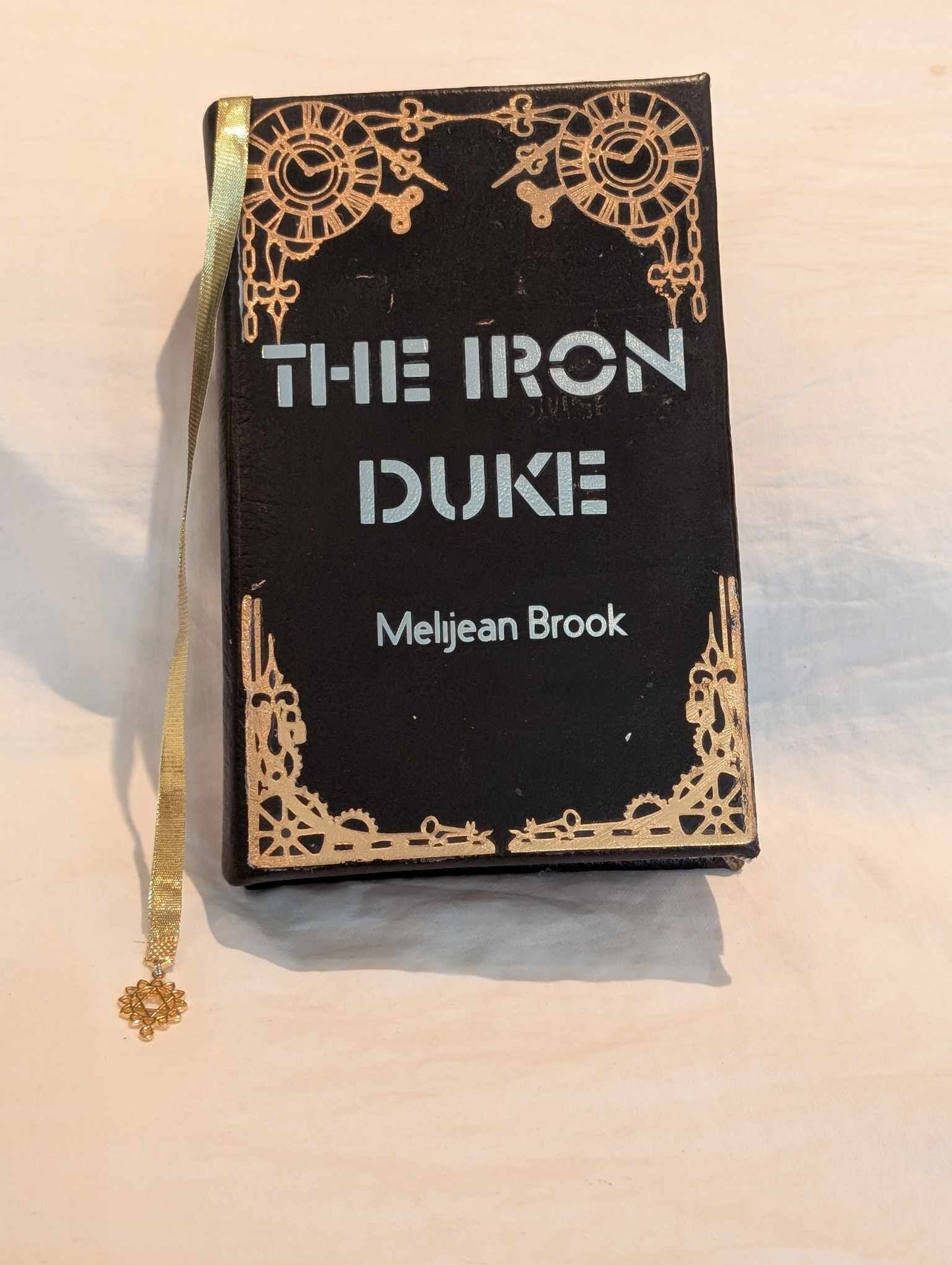 The original Booktok steampunk Book sensation The Iron Duke  rebound with book binding with custom covers. Made with Leather and Vinyl right here in Canada!